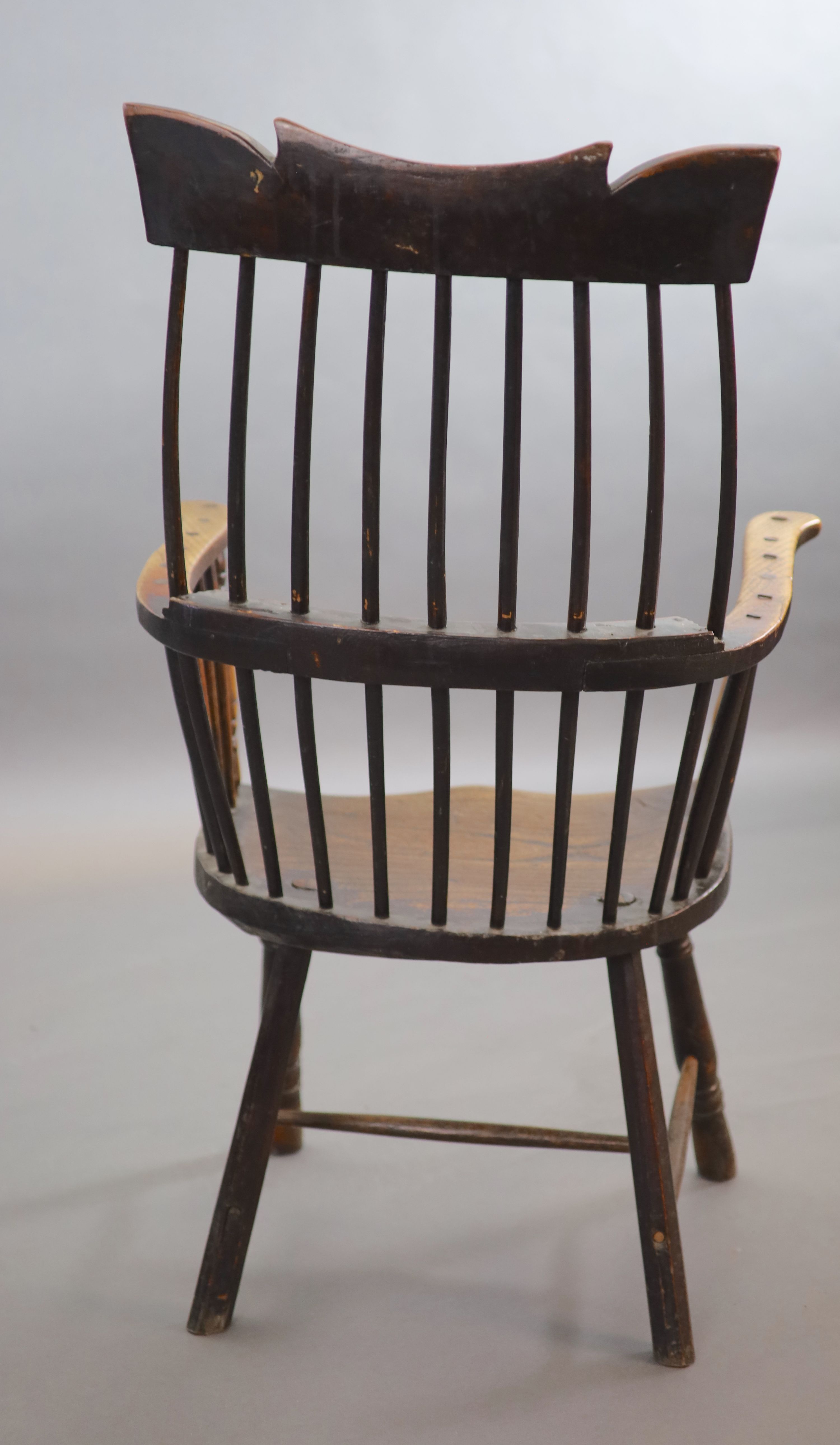 A primitive comb back Windsor armchair, possibly West Country, 67cm wide, 39cm deep, 106cm high.